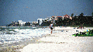 Naples Municipal beach looking north with luxury hotels and condominiums in the background.