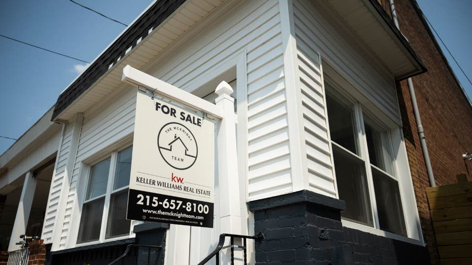 home with 'for sale' sign