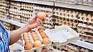 In the hands of a woman packing eggs in the supermarket